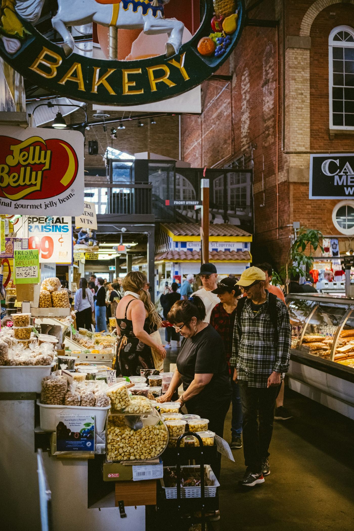 Photo: Jason Ng / Unsplash Shoppers at the bakery counter in St. Lawrence Market, Toronto