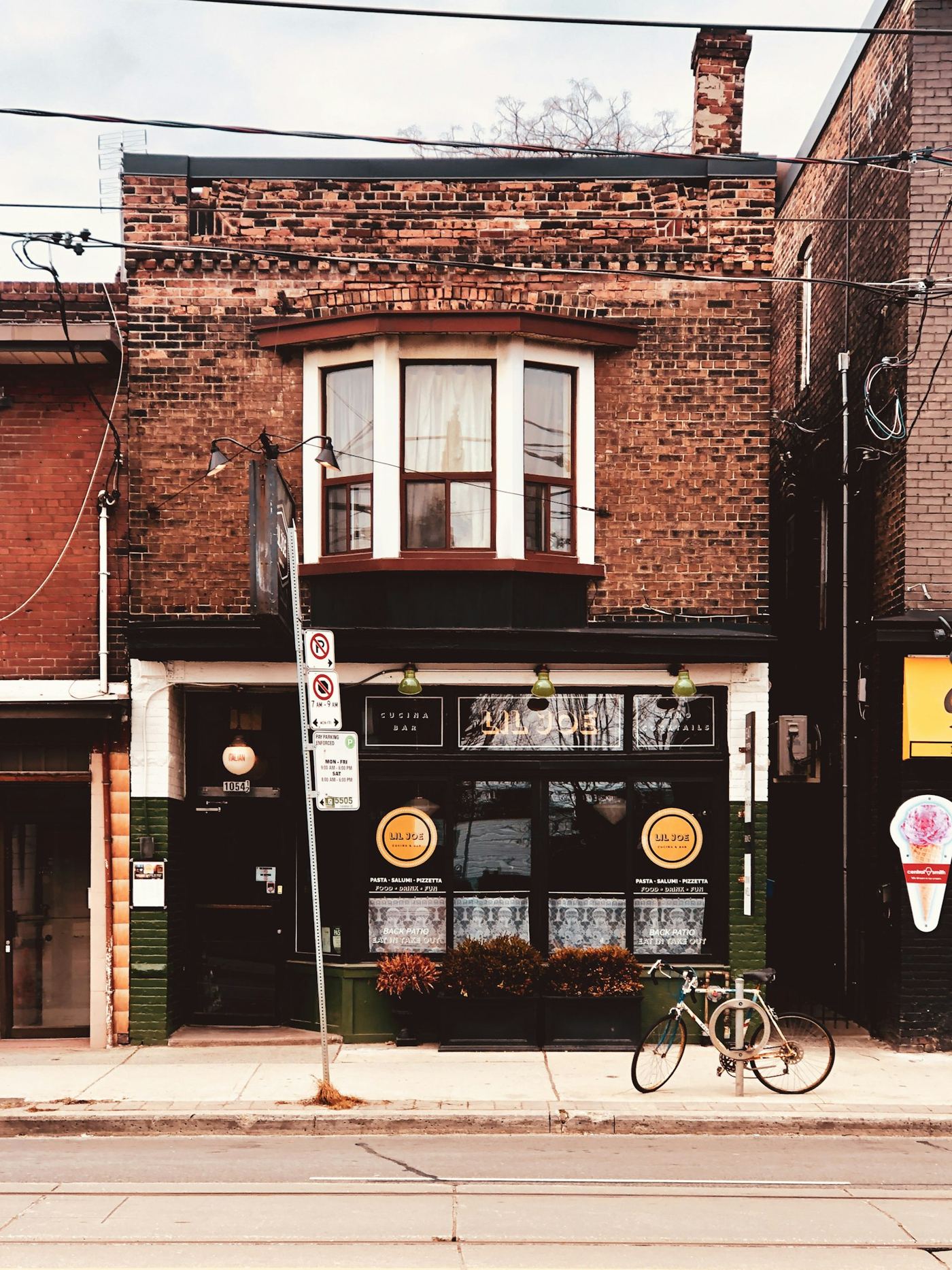Photo: Tyler Gooding / Unsplash A brick storefront on a Toronto neighbourhood street